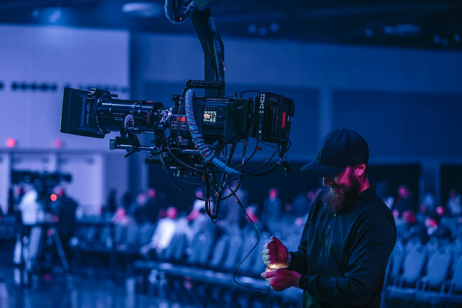 Camera operator controlling a rig at a conference venue